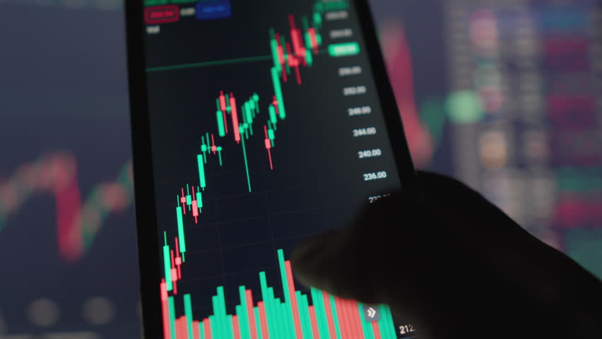 Businessman experiments with technology, using smartphone to analyze graphs charts to get real-time information about state market and movements stocks, securities, exchange rates and cryptocurrencies - Powered by Shutterstock - Get 15% off with code: PIKWIZARD15