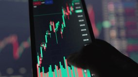 Businessman experiments with technology, using smartphone to analyze graphs charts to get real-time information about state market and movements stocks, securities, exchange rates and cryptocurrencies - Powered by Shutterstock - Get 15% off with code: PIKWIZARD15