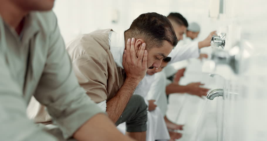 Muslim, religion ritual and men washing before prayer in bathroom for purity, and cleaning. Islamic, worship and faith of group of people with wudu together at a mosque or temple for holy practice