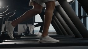 Sports shoes woman and man muscular legs feet run on treadmill workout at gym jogging sneakers running on treadmill cardio exercises couple of runners active sport people training jog in fitness club - Powered by Shutterstock - Get 15% off with code: PIKWIZARD15