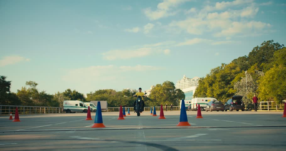 Master class from 2 motorcycle driving experts. Two expert guys skillfully go around obstacles at the training ground