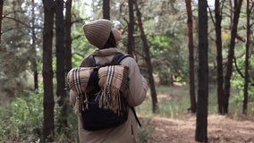 Teenage happy  girl young woman hiking with backpack in forest woodland. Video portrait of hiking teenager girl. Sport healthy concept.