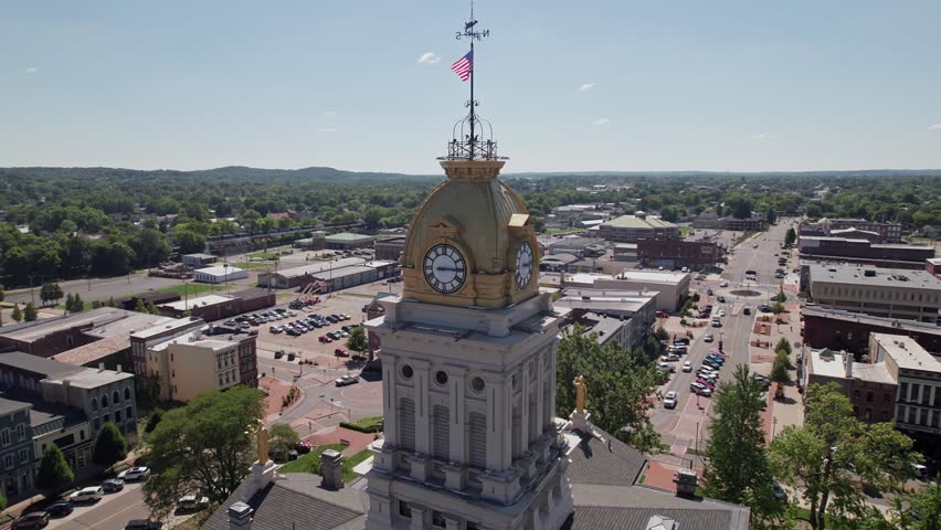 Aerial view and drone shot of clocktower government tower and building structure in the center of Newark, Ohio east of Columbus, OH with downtown buildings, small businesses, and residential district.