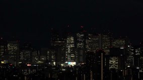 TOKYO, JAPAN : Sunrise CITYSCAPE of TOKYO. Aerial high angle view of office buildings at downtown area around Shinjuku. Japanese urban metropolis concept 4K video. Time lapse shot, night to morning.
