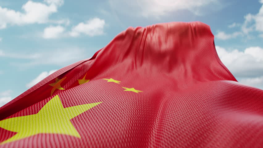 Wavy flag of China blowing in the wind in slow motion. Waving colorful Chinese flag team symbol abstract vertical background. Blue sky with clouds. World countries flying flags concept
