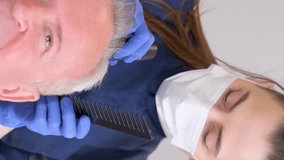 Senior man is being examined by a trichologist. Hair care concept. Vertical video
