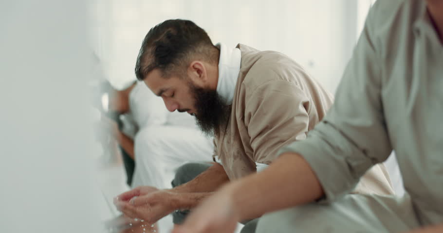 Muslim, religion and men washing face for prayer in bathroom for purity, and cleaning ritual. Islamic, worship and faith of group of people with wudu together at a mosque or temple for holy practice Royalty-Free Stock Footage #1108137619