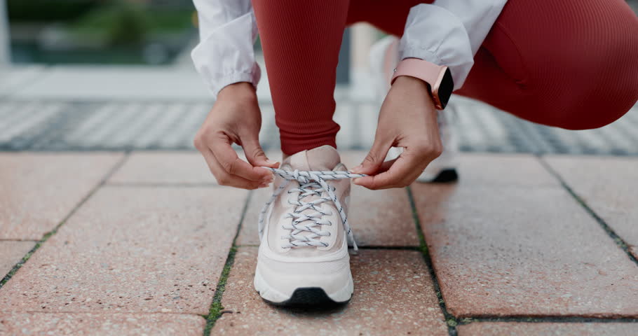 Woman, shoes and tie in running start, city or getting ready for workout, exercise or outdoor training. Active female person, athlete or runner tying shoe in sports preparation, go or sprint in town