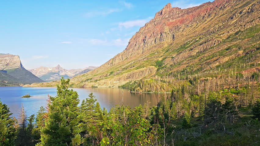 Sunrise panning of St. Mary Lake and Wild Goose Island in Glacier National Park, Montana with Fusillade, Gunsight, Dusty Star, Little Chief and Mahtotopa Mountains in the background.