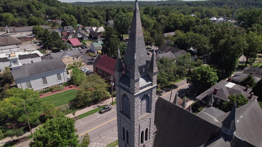 Drone shot and aerial view of multiple religious church towers and steeples in downtown Granville, OH in midwestern town in rural Ohio