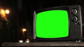 Retro TV with Green Screen at Night. Closeup. Zoom In. You can replace green screen with the footage or picture you want with “Keying” effect in After Effects (check out tutorials on YouTube). 4K.