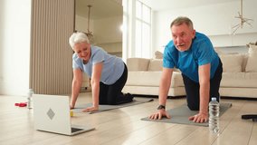 Fitness workout training. Senior adult mature healthy fit couple doing sports exercise on yoga mat on floor at home. Mid age old husband wife have training workout. Health care healthy lifestyle - Powered by Shutterstock - Get 15% off with code: PIKWIZARD15