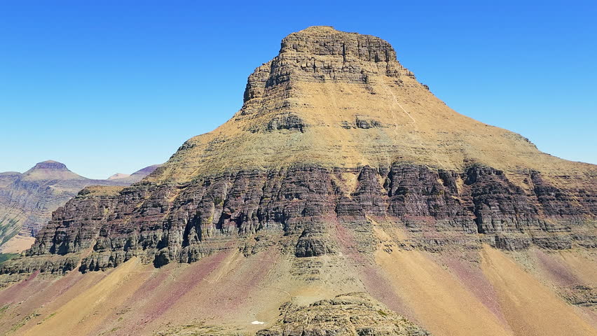 Establishing shot of Reynolds Mountain peak and Twin Lakes valley below Fusillade Mountain, in Glacier National Park, Montana.