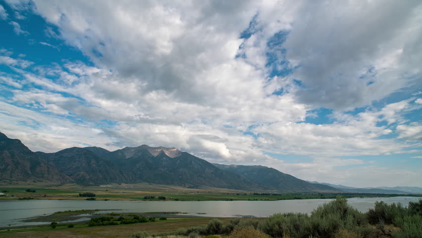 Timelapse of clouds moving over Mona Reservoir and Nebo Mountain during the summer in Utah.