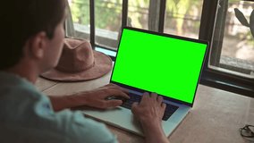 Business Man Working at Laptop Computer with Green Screen Chroma Key for Mock Up. Type Text on Keyboard or Talk in Internet Messages. Student Boy Studies Homework Content or Speaks Online at Website - Powered by Shutterstock - Get 15% off with code: PIKWIZARD15