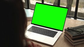 Business Woman Looking at Laptop Computer with Green Screen Chroma Key for Mockup. Businessperson Works at Video Call Meeting or Creative Lesson. Student Watching Internet Website or Online Code Tutor