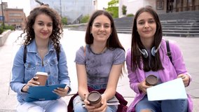Group of collage girls sitting on bench and studying for school