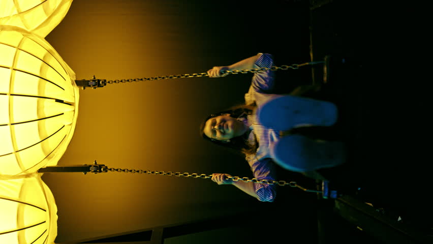 Young beautiful hispanic woman swinging happy