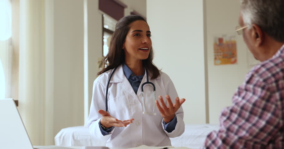 Beautiful young 35s Latina female qualified medical practitioner or cardiologist gives professional advice, health recommendation to mature patient. Treatment, chronic disease prevention, healthcare Royalty-Free Stock Footage #1108158081