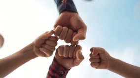 The family makes punches together. Family teamwork concept, hands on sky background. Youth cooperation join hands together. The concept of cooperation in business and teamwork. Family picnic outdoors - Powered by Shutterstock - Get 15% off with code: PIKWIZARD15
