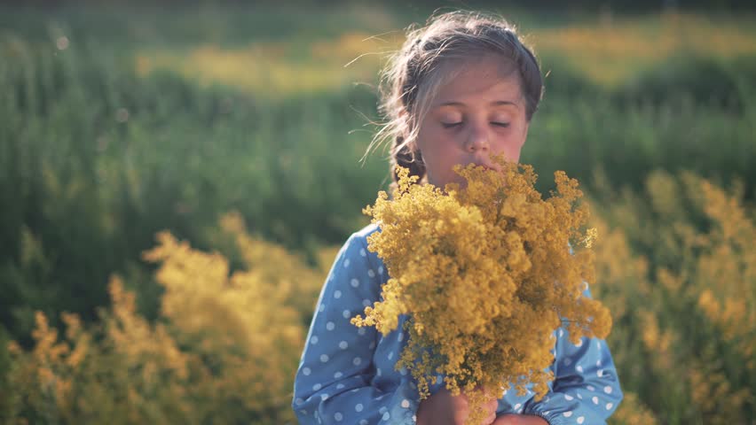 Happy girl. Child with bouquet of flowers in field. Kid dream. Girl face in park. Happy girl with bouquet of flowers. Child face in park. Dream girl. Kid smiling in park with bouquet of flowers