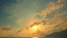 .time lapse the yellow sun going down to the sea clouds moving above the ocean..Nature video High quality footage Scene of Gradient color romantic sky sunset with cloud in the sky background. .