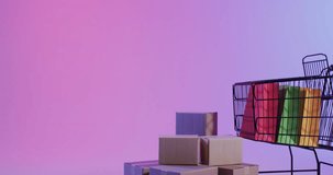 Animation of cyber monday text over shopping trolley, bags and boxes. Sales, retail, cyber shopping, digital interface, communication, computing and data processing concept digitally generated video.