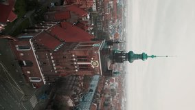 Vertical Video. Drone view of the Picturesque Historic Saint Catherine's Church in Gdansk on the Antique Buildings Background. Tourism and Vacation, Traveling Concept