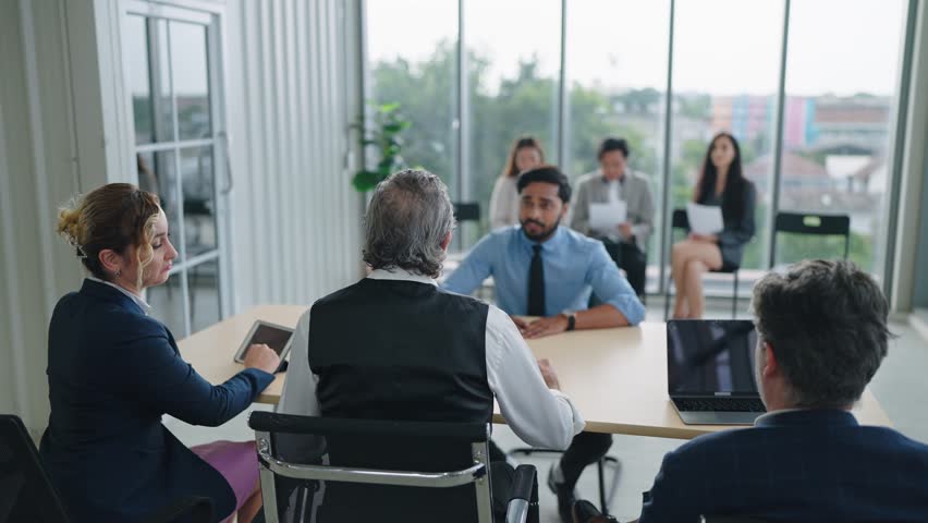 Team of recruiters having interviewing with candidate man employee in conference room. Candidate and interviewer - job interview concept