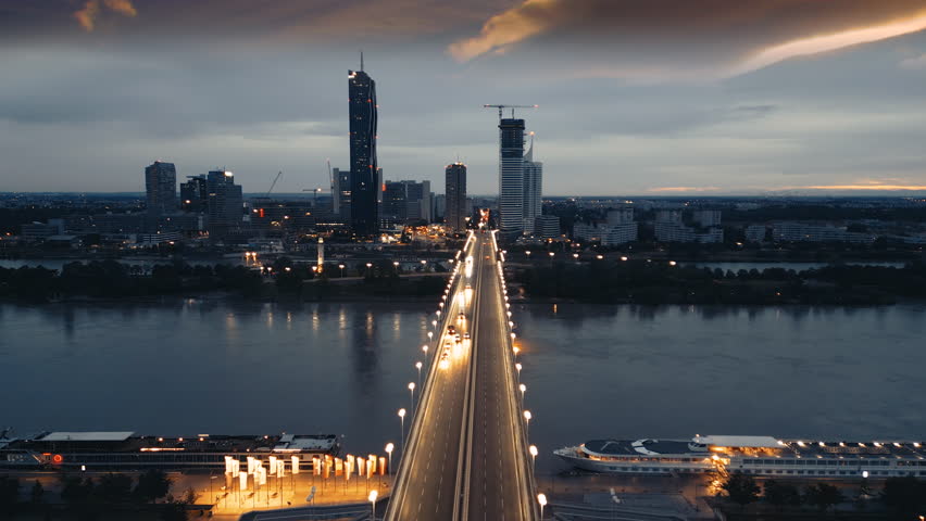 Vienna night skyline aerial view, , Austria city Vienna skyscrapers flyover brdige at night river view. Cars at night on bridge wien austria.