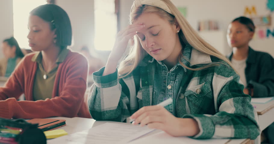 Headache, student and anxiety for test in classroom with stress for assessment, learning and scholarship at school. Exam, college and girl with burnout of studying for knowledge and development Royalty-Free Stock Footage #1108169807