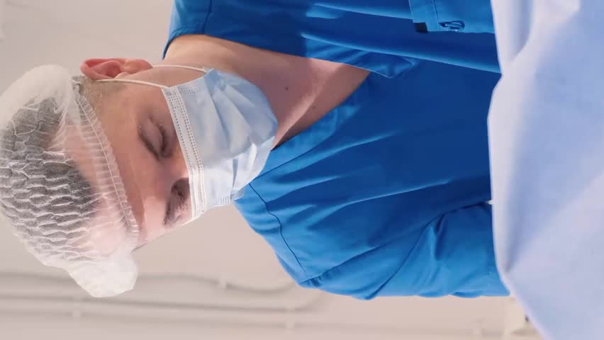 Doctor and assistant of the venous vascular surgery clinic during leg surgery. Vertical video Royalty-Free Stock Footage #1108173543