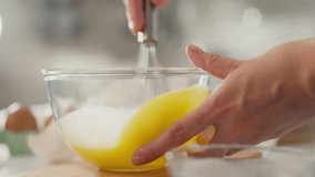 Tasty. Master cook enjoys whipping eggs with a whisk in a cozy setting. Smooth camera movement housewife whipping eggs to make pancakes showing caring pregnancy, berries - Powered by Shutterstock - Get 15% off with code: PIKWIZARD15