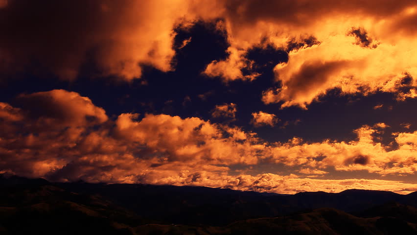 Sunset clouds above mountain peaks