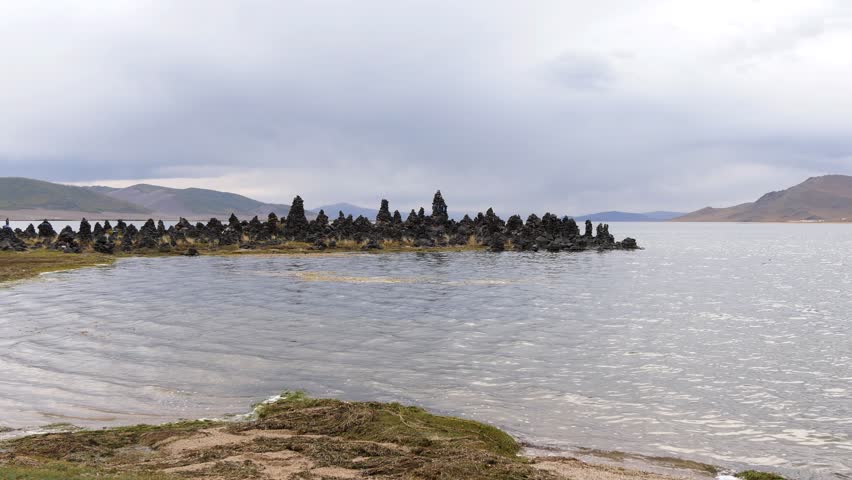 The shore of the Mongolian lake Terkhiin Tsagaan nuur on an autumn cloudy evening. | Shutterstock HD Video #1108175617