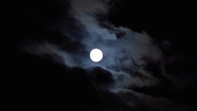Full moon in the sky with clouds at night. Full moon on a dark cloudy night, an eerie feeling of mysticism. - Powered by Shutterstock - Get 15% off with code: PIKWIZARD15