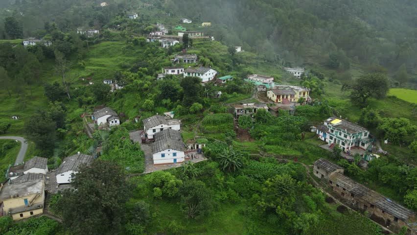 Aerial parallax shot of a small village situated in the mountains. Royalty-Free Stock Footage #1108180655