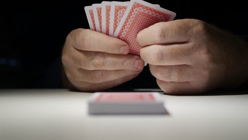Shooting with One Person Playing a Card Game Royalty-Free Stock Footage #1108181979