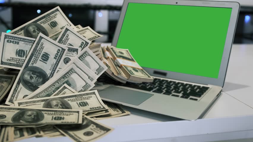 Hundred dollars paper money cash currency fall on laptop with green screen in office late night time, dramatic shot. Business making money online concept. Royalty-Free Stock Footage #1108183455