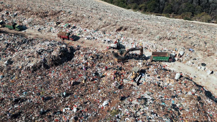Big Waste Dump and Trash Truck with Garbage in Aerial Top View. Large Rubbish Landfill with Heaps Dirt Refuse. Damage Pollution Concept of Ecosystem Land. Factory with Bulldozer Machine and Workers 4k