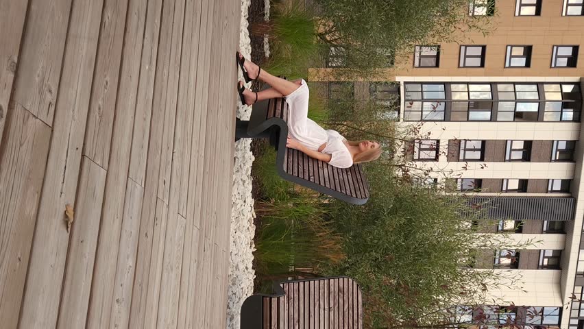 Happy young woman swinging on a rotating bench