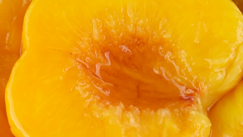 Zoom frame yellow peaches in heavy syrup, canned fruit Royalty-Free Stock Footage #1108190085