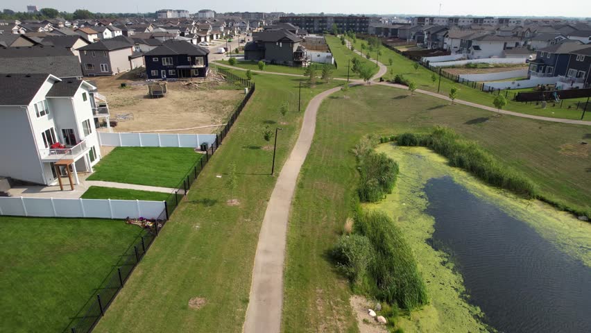 Aerial video of Kensington, Saskatoon, SK, displaying its modern homes, commercial hubs, and vibrant community spaces. A burgeoning neighborhood reflecting contemporary urban living. 