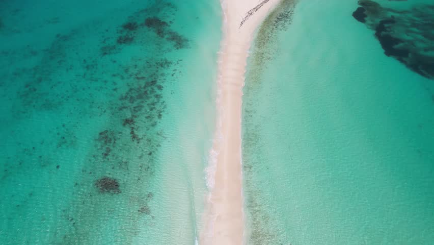 Isthmus and island of Cayo De Agua. Water sport holiday destinations. Aerial, tilt