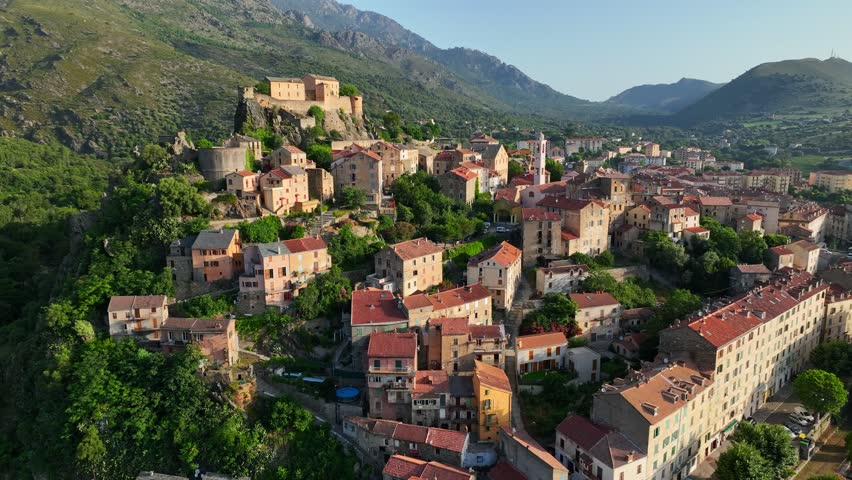 Flying over Corte old town, Corsica island, France. Morning shot of old houses on the mountain in Corte village, Corsica, France Royalty-Free Stock Footage #1108196345