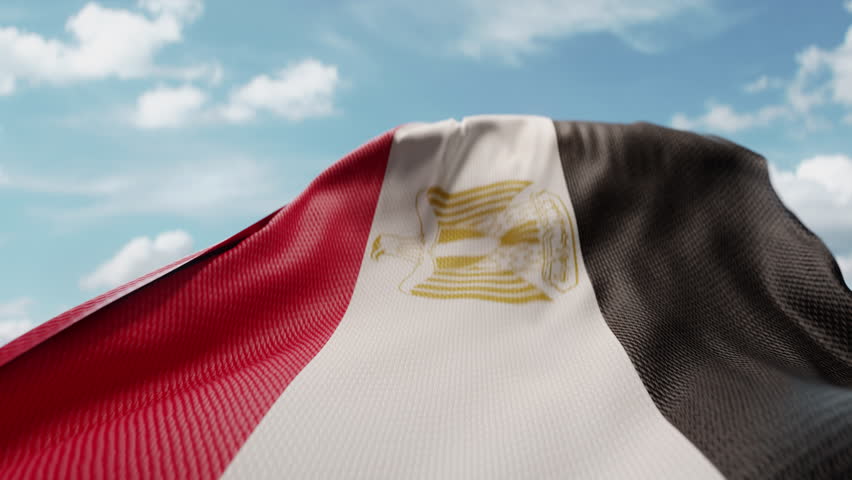 Wavy flag of Egypt blowing in the wind in slow motion. Waving colorful Egyptian flag team symbol abstract vertical background. Blue sky with clouds. World countries flying flags concept