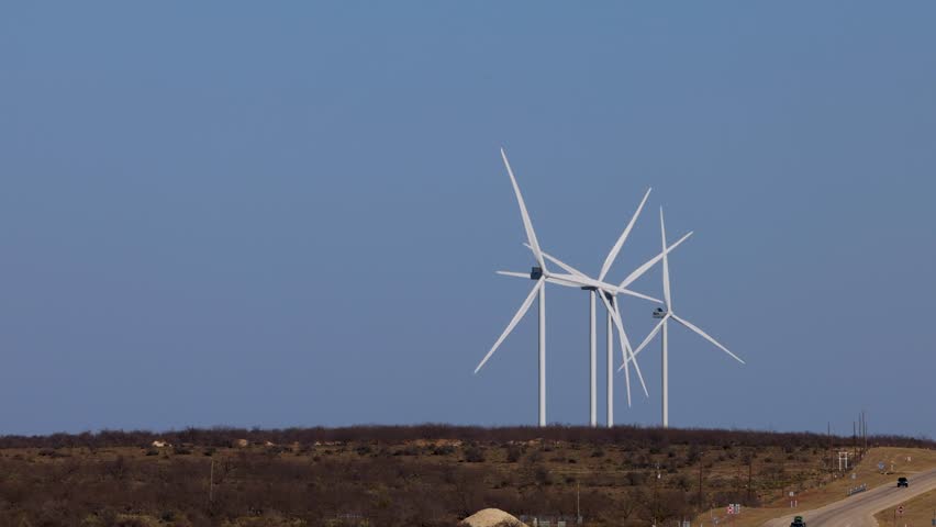 Wind turbines in Texas with cars passing on the highway, during day. Renewable energy concept in Southern USA Royalty-Free Stock Footage #1108201069