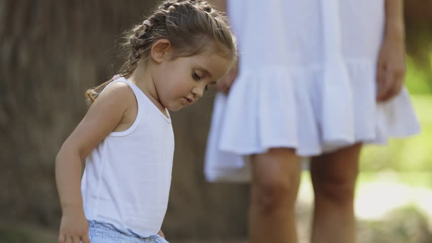 Family of mother and daughter spending time in the park
