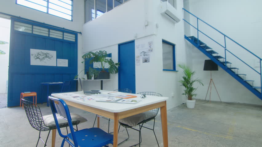 Zoom shot of office table with sketches and catalogs in architecture firm with no people