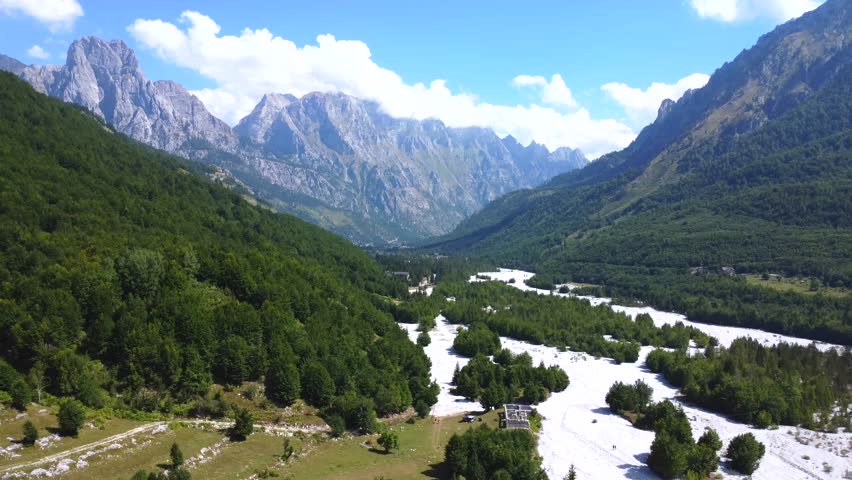 Flying above dry river in summer through Valbona valley, Theth national park, Albanian Alps, Albania